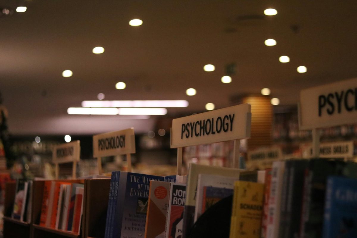 A close-up photograph of a bookstore shelf, zoomed in to reveal the title Psychology.