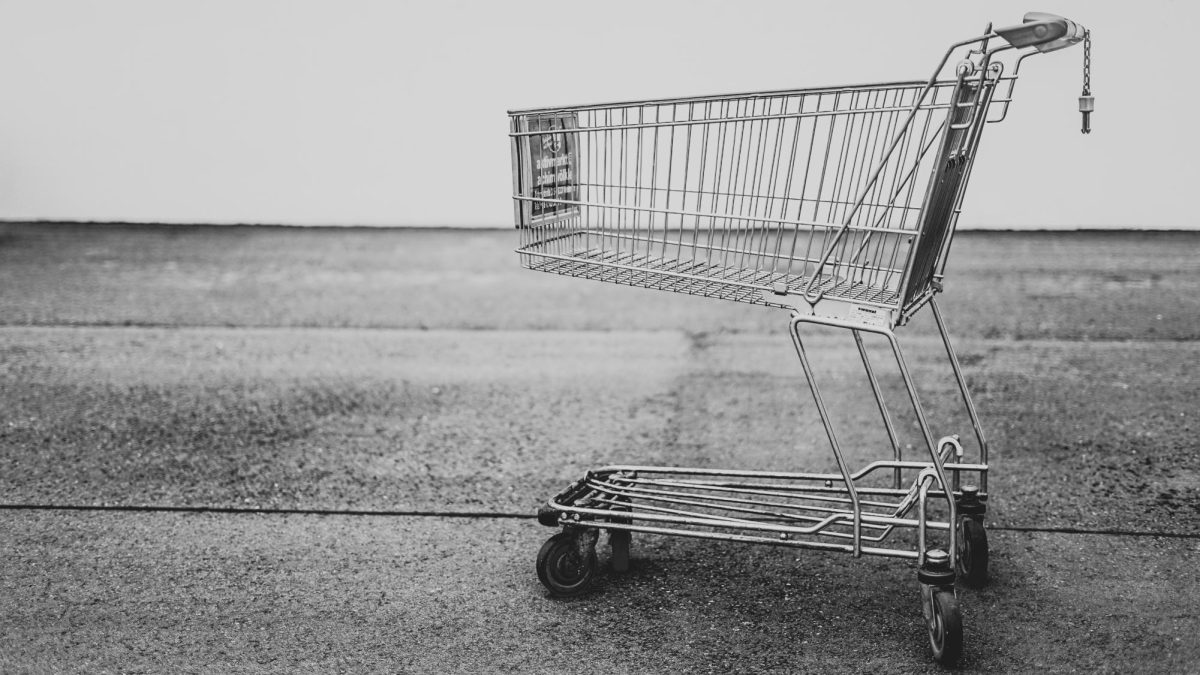 A gray-scale image of a single shopping cart.